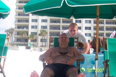 Me goofing off behind my sleeping step-father on the last vacation I'll ever share with them.